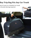 OIWAS 22-inch rolling duffel bag, black with yellow trim, being loaded into car trunk