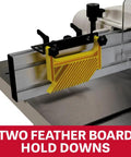 Close-up of two yellow feather boards hold downs mounted on sturdy aluminum fence of Heavy Duty 3HP Spindle Shaper.