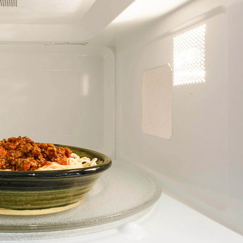 Microwave interior with 10 Pack Microwave Mica Insulation Sheets Heat Resistant Crisper Covers visible, protecting oven wall from grease.
