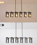 Six Light Modern Farmhouse Kitchen Island Pendant Light With Black Metal Frames And Wood Accents Big 50 Inch Chandelier in on and off states.