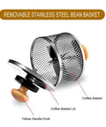 Removable stainless steel bean basket with yellow handle knob, part of electric coffee bean roaster for home use.