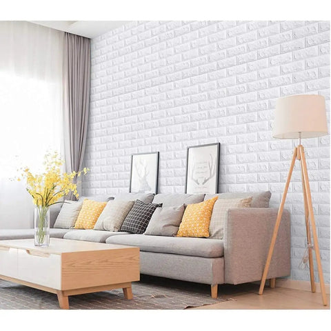 Dope 3D Brick Wall Sticker Kit, 10 Large PE Foam Tiles on living room wall, creating textured backdrop with gray sofa and decor.
