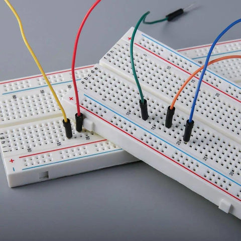 Close-up of Must Have MB 102 Breadboard 830 Point Solderless Prototype PCB Board DIY Kit for Arduino Projects with colorful wires