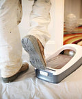Person using Heavy Duty Film Refill Rolls For E Z Floor Guard Quick Step Tear Application No Fuss Disposable Shoe Cover Alternative