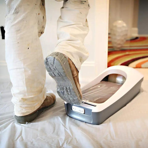 Person using EZ Floor Guard Starter Kit With Heavy Duty 2.45 Mil Film, applying shoe cover in a clean room environment