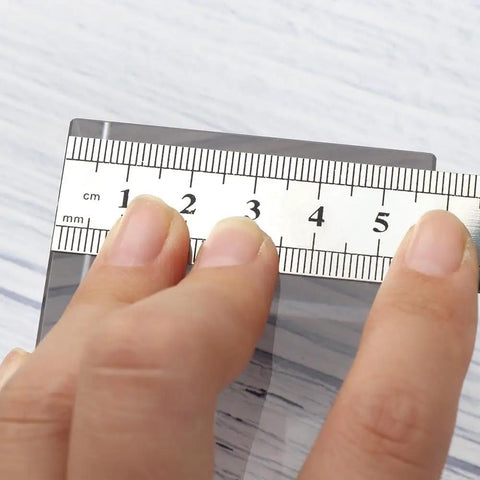 Close-up of 15 Cm Straight Ruler For Drafting And Math Class Double Sided Metal Tool with precise measurements in hand