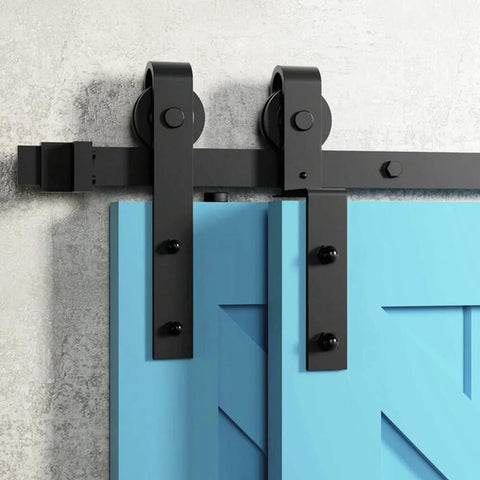 Close-up of 7Ft Bypass Sliding Barn Door Hardware Kit For Low Ceiling Spaces With Overlapping Tracks in black on a blue door