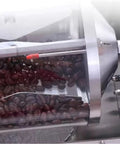 Close-up of the Game Changer Portable Coffee Roaster with roasted coffee beans inside the clear drum.