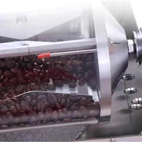 Close-up of the Game Changer Portable Coffee Roaster with roasted coffee beans inside the clear drum.