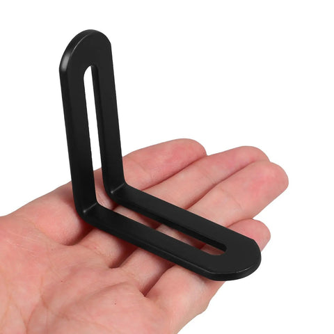 Person holding a black beefy heavy duty L shaped corner bracket from 10 pcs set, stainless steel, thickened design