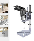 Rock Solid Drill Press Stand For Hand And Power Drills With Tight Grip Benchtop Mount Adapter showing metal drill bit with precision base.