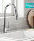Contemporary Oletto Pull-Down Kitchen Faucet With Single Handle In Chrome Finish, displayed over a white fireclay sink