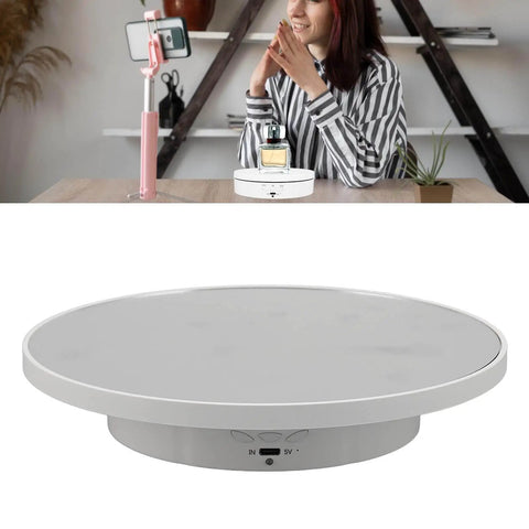 Hot 360 Degree Rotating Display Stand With Electric Motorized Turntable And USB Cable For Perfect Plastic Glass Showcase Of Jewelry Watches And Cakes In Crisp White in use with a perfume bottle.