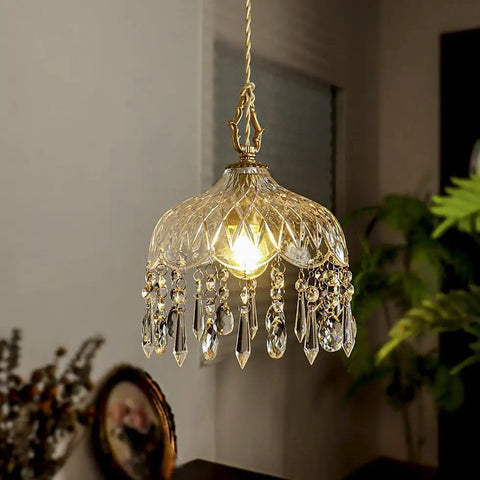 Top Shelf Vintage Crystal Pendant Light With Dope Diamond Cut Glass Shade And Legit Brass Accents Adjustable 0.5 To 70 Inch Cord hanging above illuminated in a cozy room.