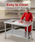 Chef cleaning Beefy Stainless Steel Pulley Workbench With Casters, Heavy Duty Prep Table With Lower Shelf For Restaurants, Garages, And Outdoor BBQs, 201 Stainless Steel Construction, Anti Corrosion Finish, Mobile Kitchen Station.