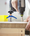 Pro-Grade T-Track Clamp Quick-Act Hold-Down For Woodworking And Carpentry in use on a workbench with drill press clamp tool
