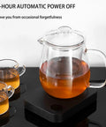 Smart Desk Mug Warmer With Three Adjustable Heat Modes And Built In Safety Timer For Auto Shut Off with glass teapot and cups.