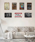Safety First Eye Protection Required Metal Tin Sign 8x12 Inches displayed in living room with assorted vintage signs