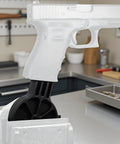 Lockdown Gun Vise Block For AR Rifle And Glock Pistol Heavy Steel Table Fixture securely holding Glock pistol for maintenance.