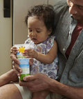 Parent holding Mineral SPF 50 Kids Sunscreen Lotion With Zinc Oxide And Titanium Dioxide Broad Spectrum UVA UVB 6 Fl Oz with child.