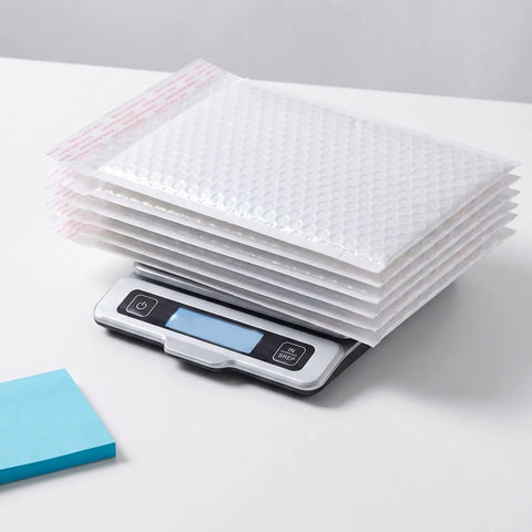 White Bubble Mailers 30 Pack 6x8 Inch Padded Envelopes For Small Biz Shipping on a digital scale