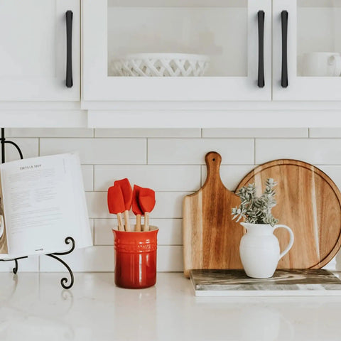 Kickass Five Inch Matte Black Kitchen Cabinet Handles Ten Pack on white kitchen cabinets with decorative utensils.