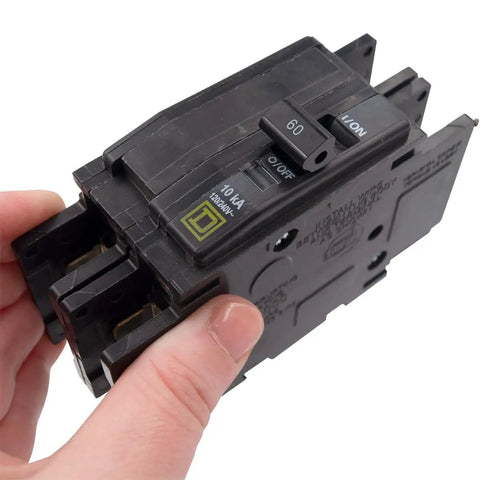 Hand holding 230 Volt 60 Amp Two Pole Circuit Breaker QOU260 Din Rail Mounted for Electrical Panels and Industrial Control Systems