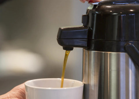 ECAL22S Eco Air Lever Airpot With Glass Vacuum Insulated Beverage Dispenser 2.2 Liter pouring coffee into cup