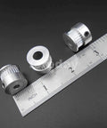 Heavy Duty Alloy GT2 Synchronous Timing Pulley Five Pack With 25 Teeth 6mm Wide And 8mm Bore, showcasing three pulleys beside a ruler.