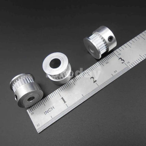 Heavy Duty Alloy GT2 Synchronous Timing Pulley Five Pack With 25 Teeth 6mm Wide And 8mm Bore, showcasing three pulleys beside a ruler.