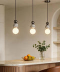 Aolyzmt Natural Alabaster Marble Pendant Light, Modern Cylinder LED Hanging Lamp above kitchen island with fruit bowl.