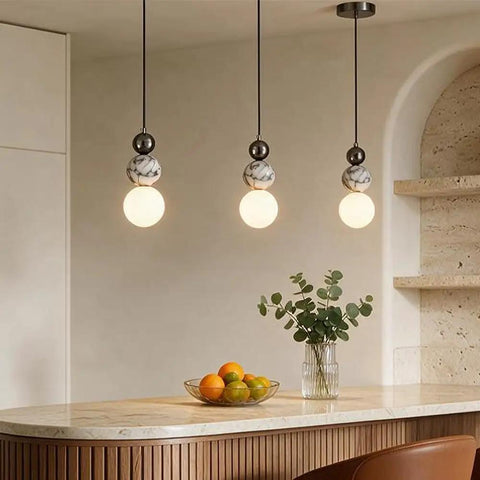 Aolyzmt Natural Alabaster Marble Pendant Light, Modern Cylinder LED Hanging Lamp above kitchen island with fruit bowl.