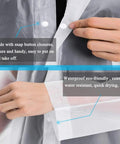 Close-up of hands fastening snap buttons on Two Pack Reusable EVA Rain Ponchos For Adults Stay Dry In Any Downpour Lightweight Waterproof Rain Gear