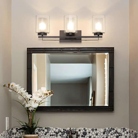 Dope 3 Light Bathroom Vanity Light in dark bronze with dual glass shades above a mirror, shown in a bathroom setting