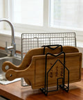 Compact Cutting Board Rack Organizer For Kitchen Countertop And Lids Flat Steel Stand holding cutting boards on countertop.