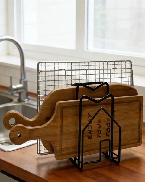 Compact Cutting Board Rack Organizer For Kitchen Countertop And Lids Flat Steel Stand holding cutting boards on countertop.