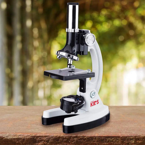Rock Solid 1200X Monocular Compound Microscope With Killer LED Lighting And A Straight Up 52 Piece Science Starter Kit For Students Crushing Biology And Chemistry Labs on a wooden table.