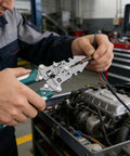 Kick Ass Heavy Duty Foldable Wire Stripping Pliers With Precision Electrical Crimping And Sharp Cutting Blades being used on wires in a car engine.