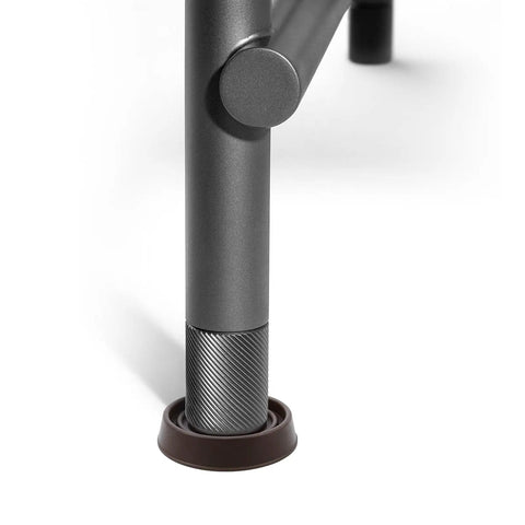 Close-up of chair leg in 1.5 Inch Round Rubber Furniture Caster Cups 4 Pack Dark Brown Floor Protectors For Chairs Tables Sofas Protect Hardwood Floors And Prevent Scratches With Secure Non Slip Fit.