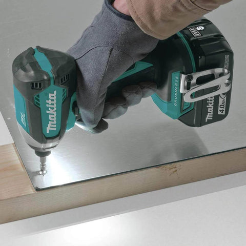 XT269M 18V LXT Brushless Cordless Impact Driver drilling into a metal surface, operated by person wearing glove, close-up view