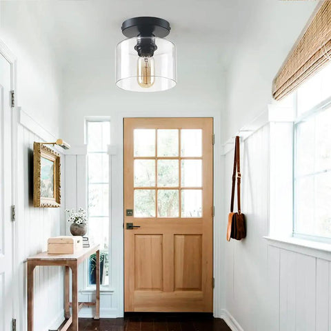 Modern Semi Flush Mount Ceiling Light With Matte Black Finish And Clear Glass Shade showcased in hallway setting.