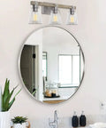 23 Inch 3 Light Farmhouse Vanity Light with Clear Tapered Glass Shades in bathroom setting