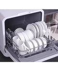 Compact Tabletop Dishwasher With Plug And Play Setup No Plumbing Needed Self Draining Front Opening Auto Dry And Storage Fits Large Plates. Open rack filled with large white plates and mugs.