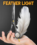 Six And A Half Inch Matte Black Luxury Hair Scissors Ultra Sharp Stainless Steel Barber Shears above hand with feather light text