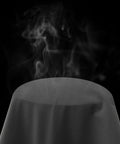 Steam rising from the surface of a dark material object, representing its waterproof and windproof properties.