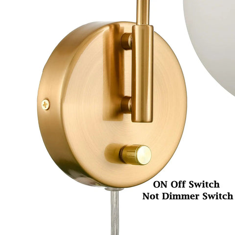 Close-up of Mid Century Modern Wall Sconce with Switch Gold Brass Finish showing on-off switch and part of opal white glass globe.