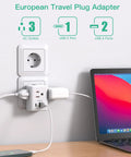 Six In One European Travel Plug Adapter With USB Ports And Type C Power For US To Europe in a wall outlet with laptop