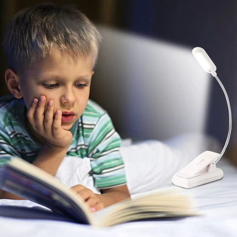 Child reading in bed with Clip On Book Light With Seven LEDs And Nine Color Temperature Modes Warm White Cool White Daylight Eye Care Lamp