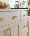Champagne Bronze Cup Cabinet Pull 5 1 16 Inch Center To Center 6 3 8 Inch Overall Length Stature Collection Drawer Pull installed on cabinets