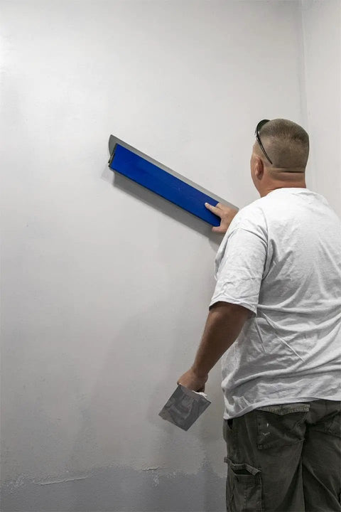 Man using ProSkim Drywall Tool For Ultra Smooth Finish With Lightweight Skimming Blades, Ergonomic Non Slip Handle, Easy Skim Coating, Perfect For DIY And Pros, Made In USA, 31.5 Inch on wall